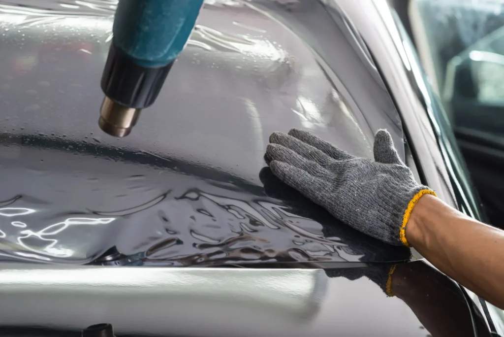 window tint applied on silver car with heat gun